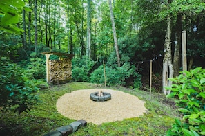 Firepit by a small stream in the backyard