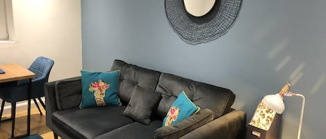Lounge area with comfy Sofology sofa and love seat.