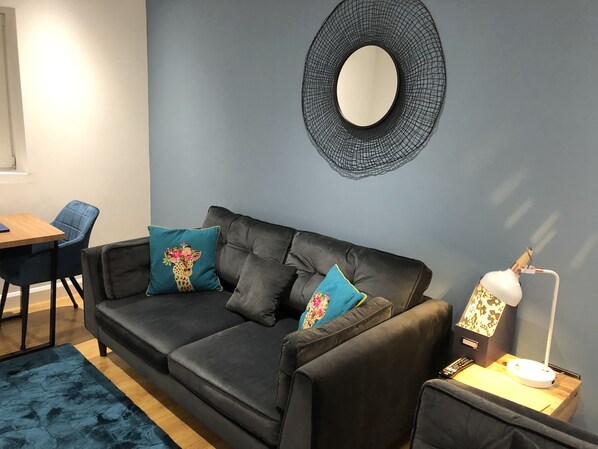 Lounge area with comfy Sofology sofa and love seat.