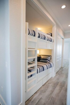 Twin over twin bunk beds in the hallway.  There is a door that can be closed off to the living room for more privacy