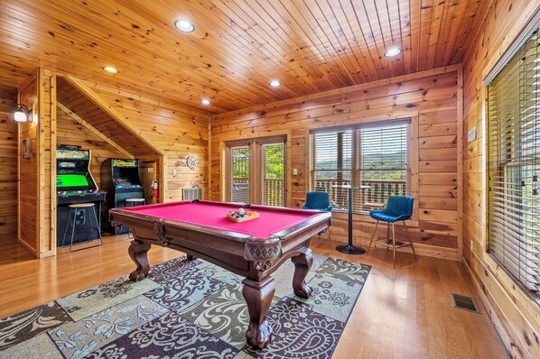 Recreation room on lower offers a mountain view. Hot tub on this level's deck.