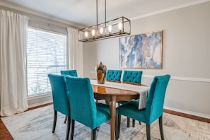 Formal dining area with tufted dining chairs.