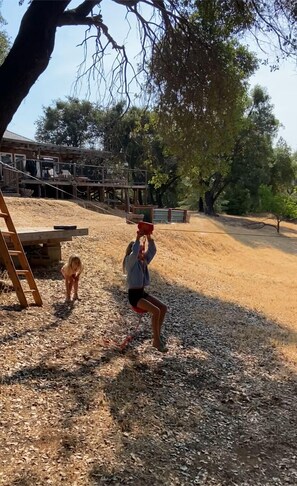 Let your kids have fun on our 80 foot zip-line. Use at your own risk.