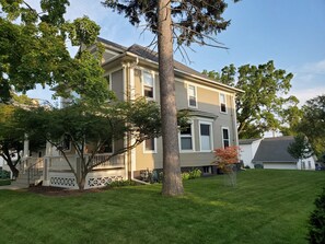 Side view of property with beautiful mature trees.