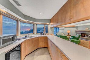 The well-appointed wet bar is the perfect spot to dine or snack. There is a full kitchen below for those extra special meals!