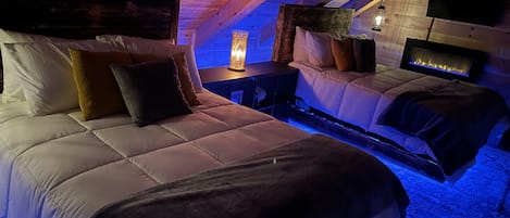 The Loft area has two Queen floating beds w/ LED lights! Also TV and fireplace!