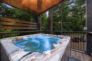 HOT TUB surrounded by views of the forest