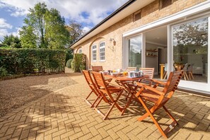 Maltings Lodge, Chelsworth: Patio area is accessible through the doors from the kitchen