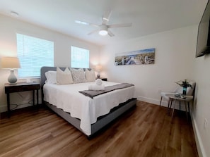 Master bedroom with King size bed, sitting area, flat screen tv, closet space & private bathroom