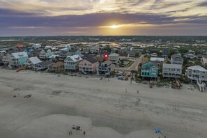 Experience beachfront living in this stilted retreat, where golden light fades over the sand and the ocean’s hush invites you to unwind just steps from the shore.