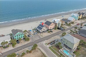 Bask in coastal splendor where sunrise greets you each morning. This oceanfront home offers direct beach access and unforgettable views beneath a sky brushed with soft color.