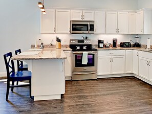 Peninsula with stools is a great spot for morning coffee or for chats with the chef.