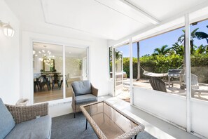 Screened in patio with table and seating