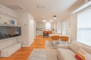 Open living/dining/kitchen with smart tv and all appliances