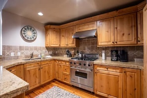 Gorgeous fully stocked kitchen with bar seating.