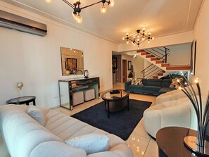 Striking living on 1st lvl with half bath, next to a bedroom dining and kitchen.