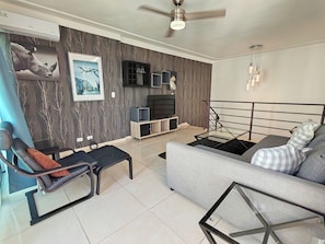 Convenient living area on 3rd level, with Sofa bed, A/C, Ceiling fan, and TV.