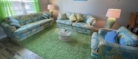 FUN AND BEACHY! Hang out in this Clutter free, cozy, bright colored living room.