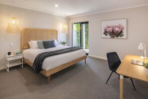 Retreat to the tranquil primary bedroom, featuring a king bed and a dedicated study nook—perfect for catching up on work or relaxing with a good book.
