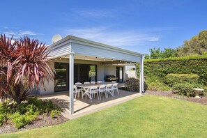 Savor alfresco dining or relaxed afternoons on the sunny patio, set amidst lush greenery—perfect for BBQs, family meals, or evening drinks.