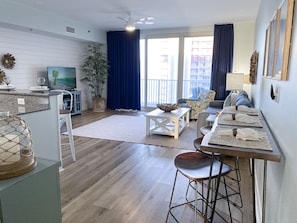 The living room offers ample seating with a queen sized sofa sleeper and two coordinating chairs