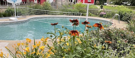 Perennial gardens surround the pool and deck.