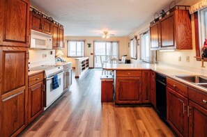 Kitchen with bar seating (3 stools) and dining table (seats 8)