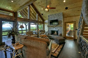 The Vue Over Blue Ridge- Living room area with a fireplace and deck access