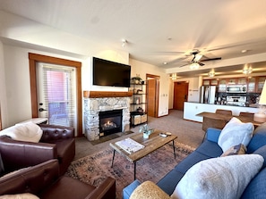 Open living area large flatscreen TV, and gas fireplace.