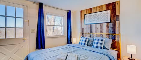 The bedroom has a stunning accent wall and sweeping mountain views