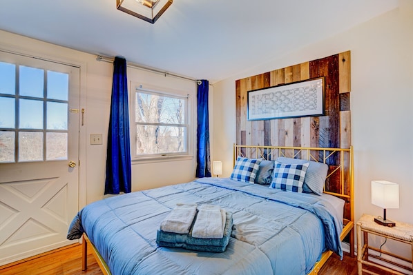 The bedroom has a stunning accent wall and sweeping mountain views
