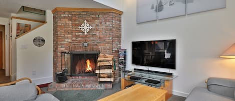 Warm up after a day of skiing in the cozy living room with wood burning fireplace.