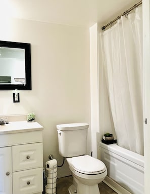 Full bathroom with toilet, sink, and bath/shower!