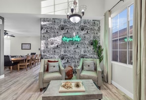 Living room cactus accent wall with neon sign