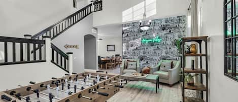 Gorgeous living room with cactus accent wall and foostable