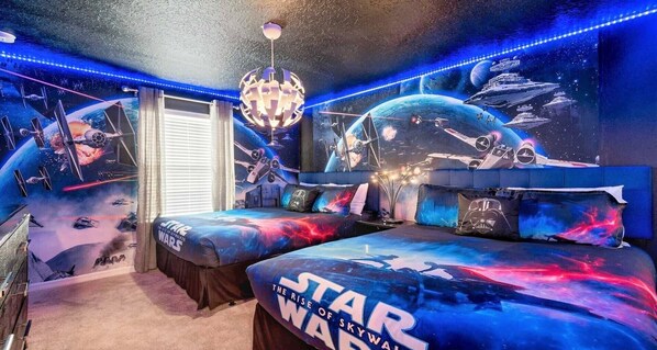 Experience luxury and comfort in our spacious Star Wars themed bedroom, promising you a restful night's sleep.