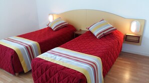 The second bedroom contains 2 Single beds.