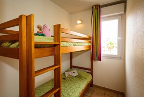 The cozy sleeping alcove features a bunk bed.