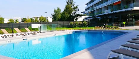 Lounge by the pool in the sunshine.