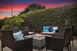 Comfortable seating for eight around the firepit in the backyard.