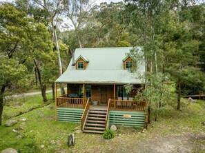 Cedar Cottage with Front Deck: A cozy retreat for relaxation and outdoor enjoyment.