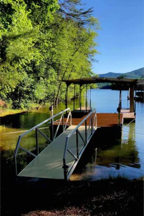 Private dock with covered boat slip and swim platform.