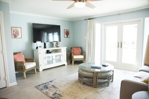 Living room. Doors open onto waterfront deck.