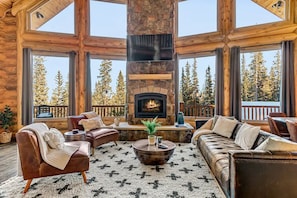 Behold the splendor of 30-foot ceilings framed by massive timbers and panoramic windows, offering unparalleled views .