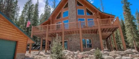 Immerse yourself in the majesty of the mountains at this breathtaking log cabin, perched at an elevation of 11,000 feet. Surrounded by towering trees, it offers stunning views, four king-sized beds, a brand-new hot tub, and a garage.