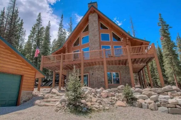 Immerse yourself in the majesty of the mountains at this breathtaking log cabin, perched at an elevation of 11,000 feet. Surrounded by towering trees, it offers stunning views, four king-sized beds, a brand-new hot tub, and a garage.