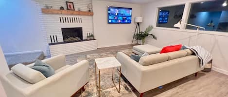 Gorgeous living room with large TV and fireplace!