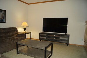 Family room off the kitchen with 70 inch flat screen TV.