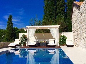 Sunbeds on the outdoor terrace next to the private pool of the Croatia luxury villa Red Rose in Mlini near Dubrovnik