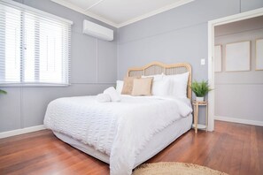 Master bedroom features a king sized bed.